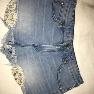 Free people denim shorts with floral pockets